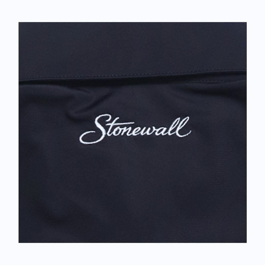 Close-up of a dark navy fabric surface with the word 'Stonewall' embroidered in white script across the center.