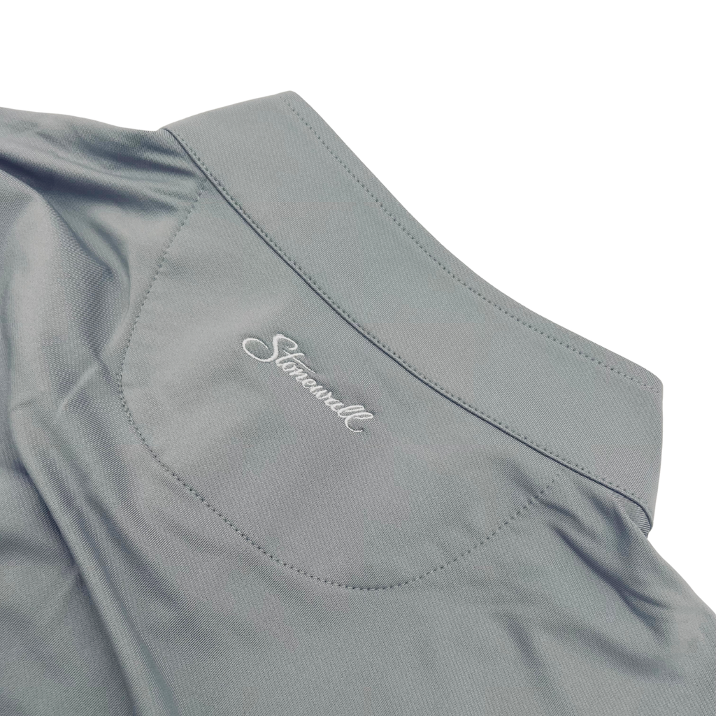 Close-up of a light gray collared quarter zip with a stitched back with panel and the embroidered Stonewall logo on the collar, set against a plain white background.
